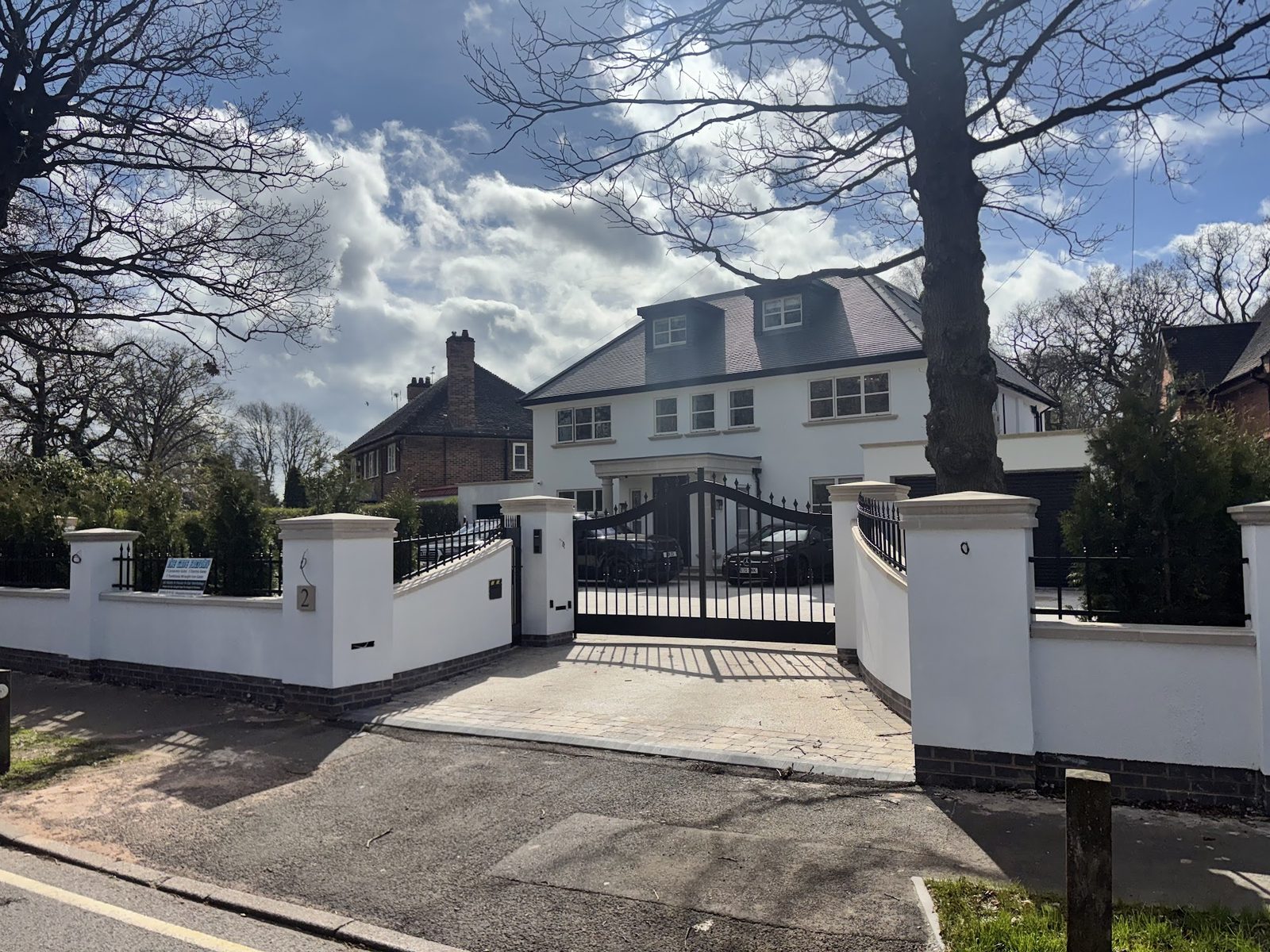 Driveway gates across a wide shared entrance