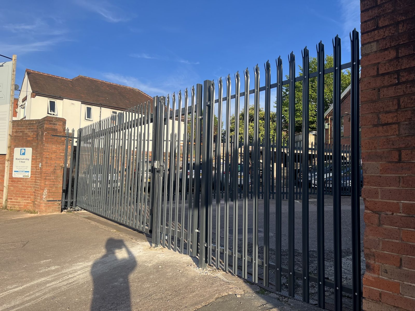 Tall spear top security fencing across a yard entrance