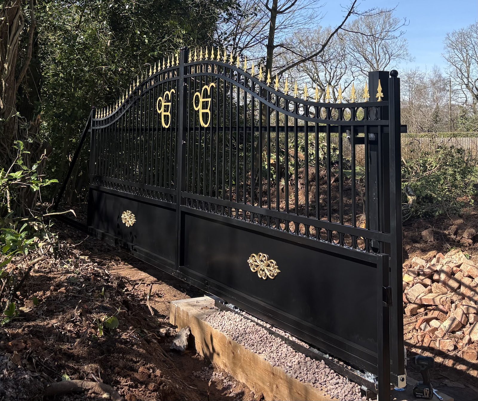 Refurbished ornate gates with gilded scrollwork