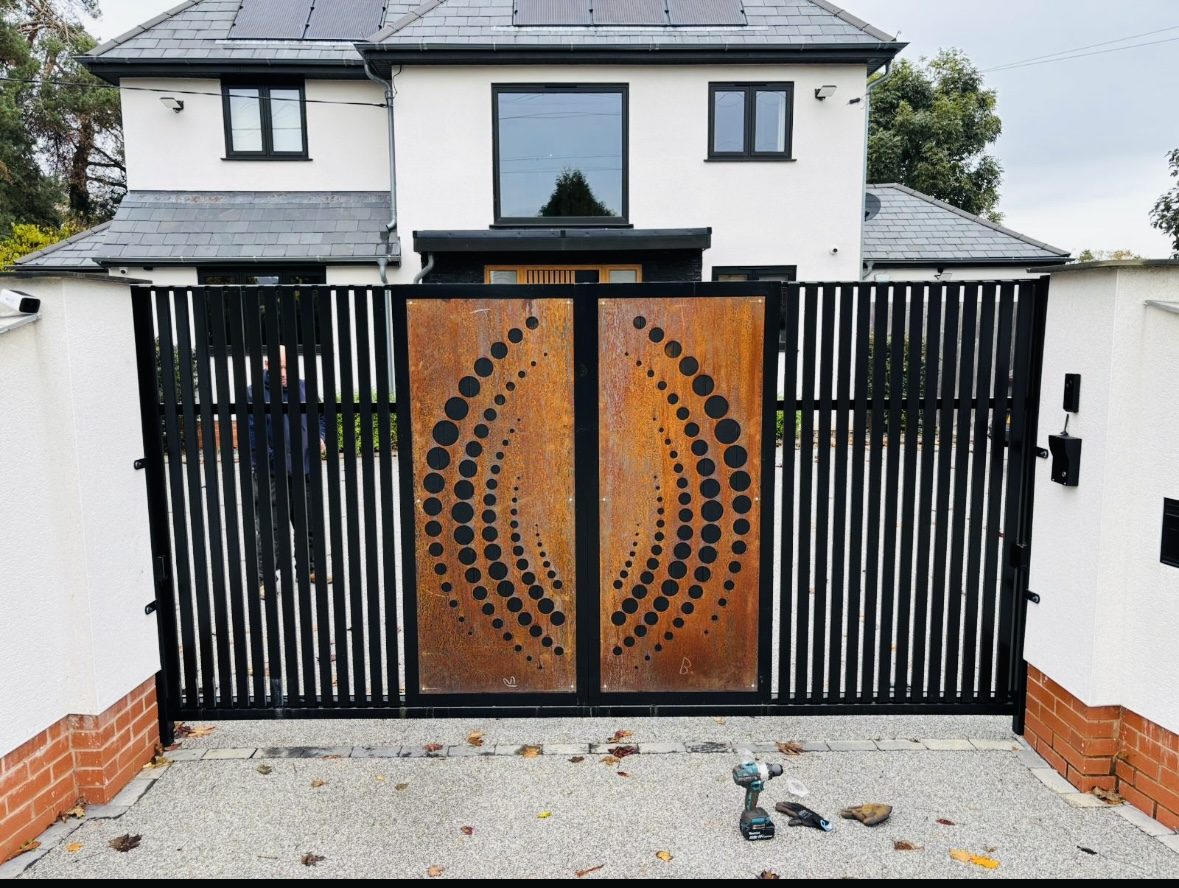 Bar gates with a corten steel sunburst infill panel